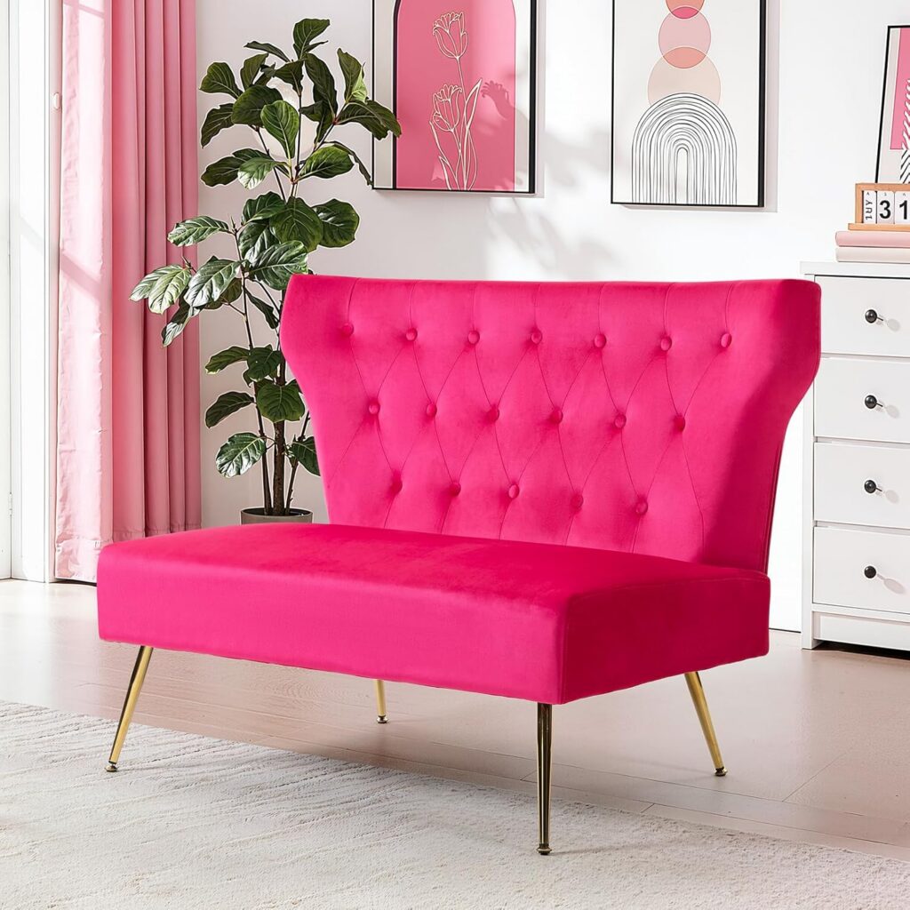 Fuchsia velvet armless loveseat sofa with tufted upholstery and gold metal legs for bedrooms or small apartments