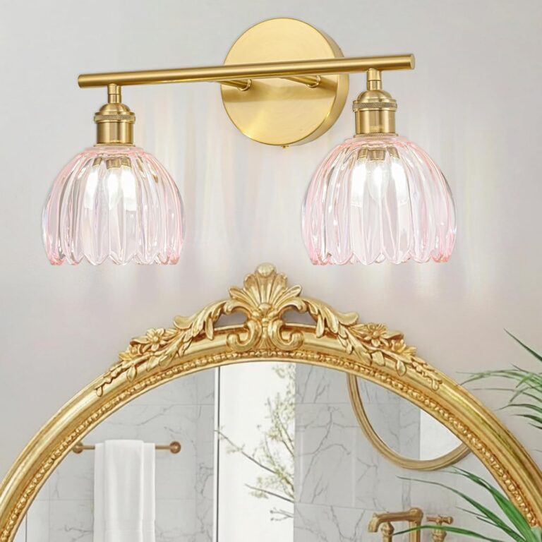 gold bathroom vanity light fixture with pink tulip glass shades mounted above mirror