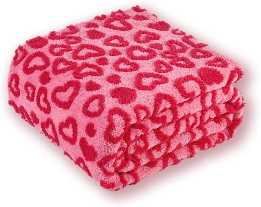 Hot pink fluffy heart throw blanket draped over a chair with soft plush microfiber texture