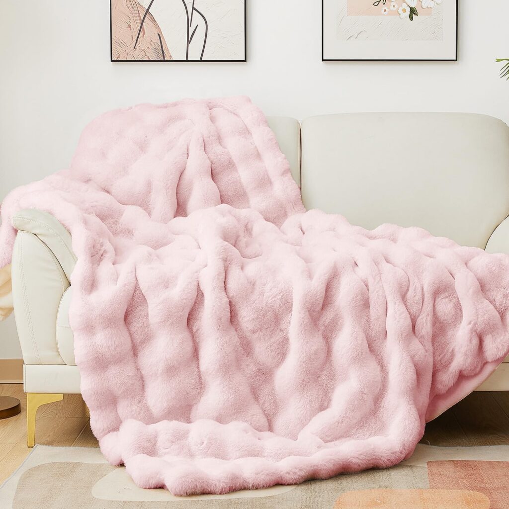 light pink bubble faux fur throw blanket draped over couch with soft plush textured design