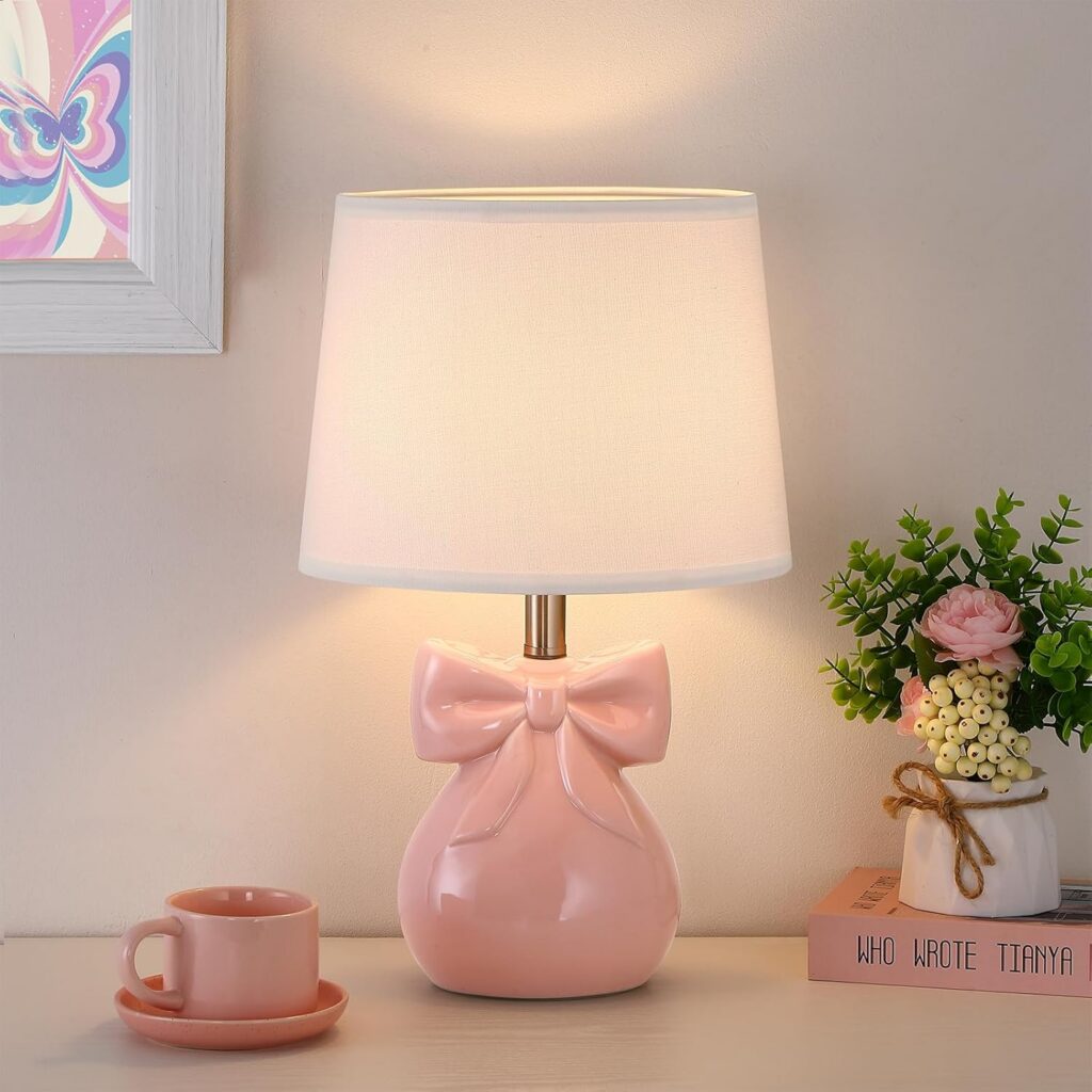 pink ceramic bow table lamp with white linen shade on bedroom nightstand