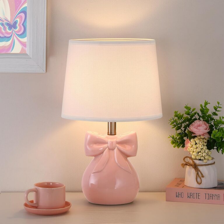 pink ceramic bow table lamp with white linen shade on bedroom nightstand