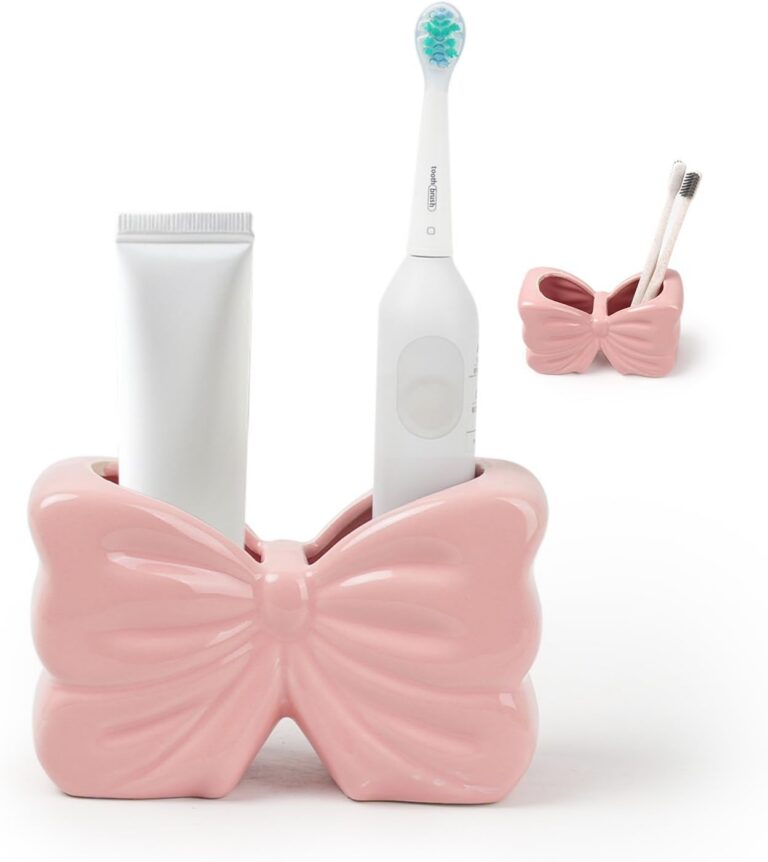 pink ceramic bow toothbrush holder with two compartments for bathroom countertop organization