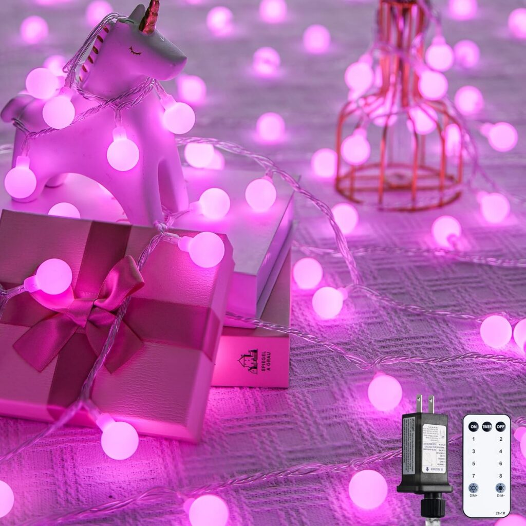 pink frosted globe fairy string lights decorating a cozy bedroom with soft ambient lighting