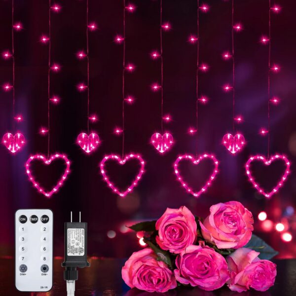 pink heart-shaped LED curtain fairy lights hanging on a bedroom window with romantic glowing ambiance