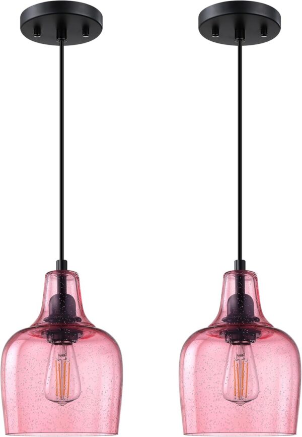 Pink seeded glass pendant ceiling lights with black finish hanging above a kitchen island