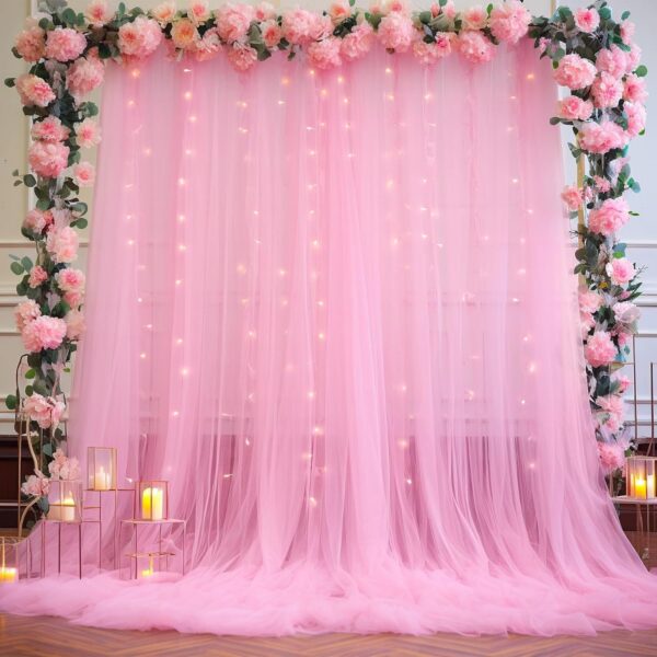 pink tulle backdrop curtains with warm white fairy lights for baby shower or birthday party decorations