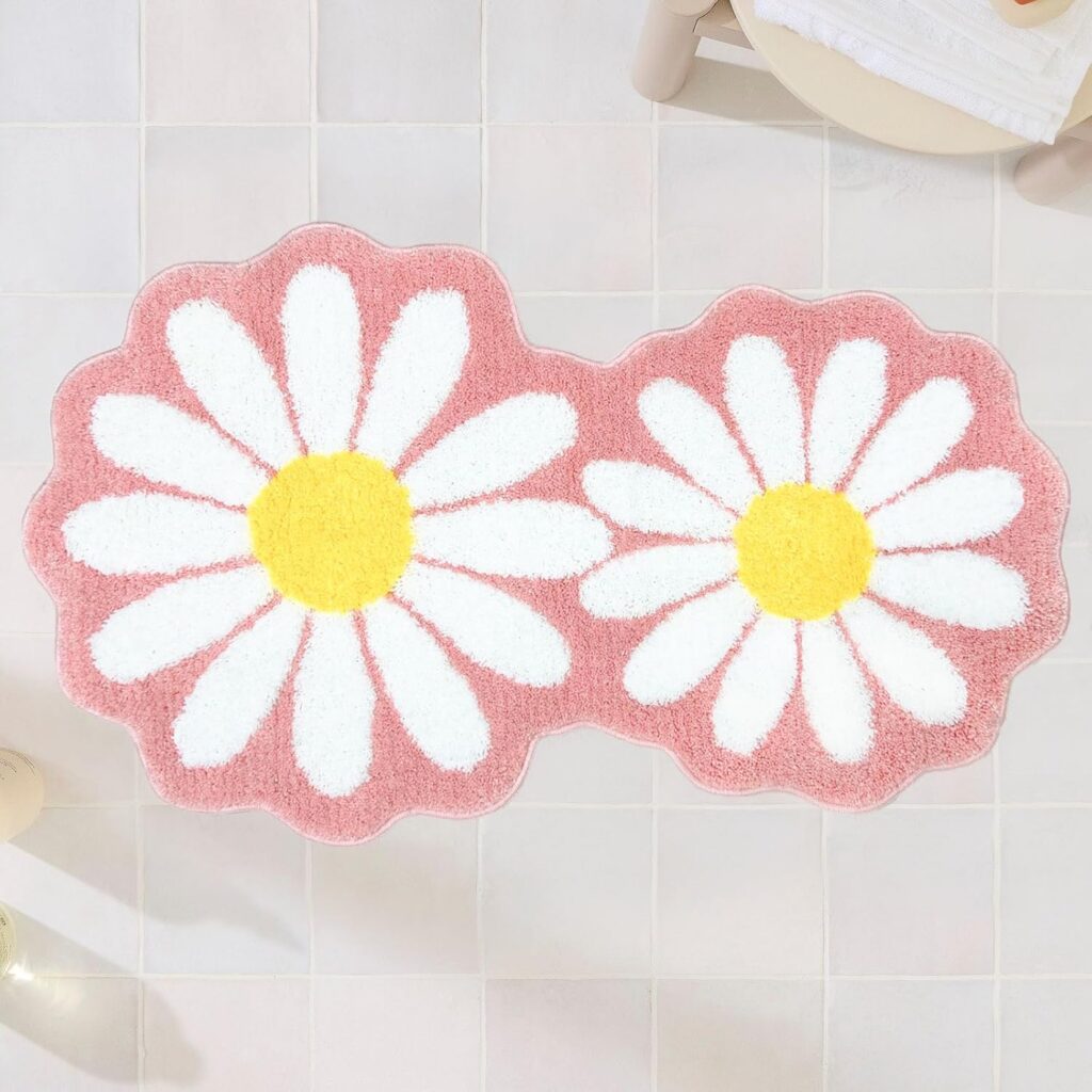 Pink and white daisy flower bath rug with soft high-pile microfiber fibers, non-slip backing, and absorbent construction designed for bathrooms, bedrooms, vanity areas, and preppy floral room décor.