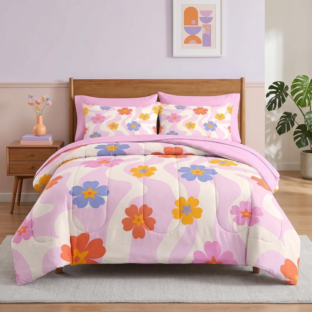 Juicy Couture queen/full reversible comforter set featuring pink and white cabana stripes with matching pillow shams and three decorative accent pillows for glamorous bedroom décor.