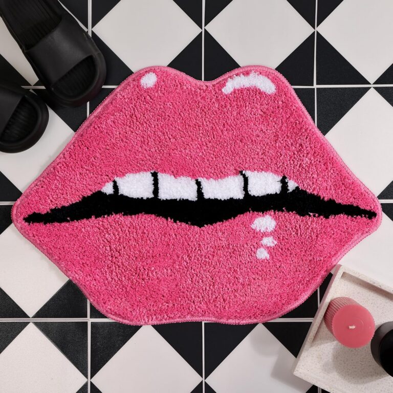 Pink lips-shaped plush bath mat with soft microfiber pile, absorbent surface, and non-slip backing, designed as a fun decorative bathroom rug for feminine, coquette, and playful room décor.