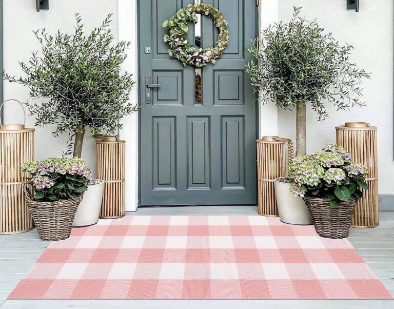 Pink and white buffalo plaid woven cotton outdoor rug with a washable low-profile design, perfect for layering beneath welcome mats on front porches, entryways, patios, kitchens, and farmhouse-inspired living spaces.