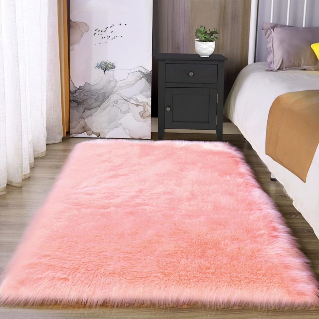 Pink faux fur sheepskin area rug with fluffy high pile texture for bedrooms, dorm rooms, living spaces, and teen room decor