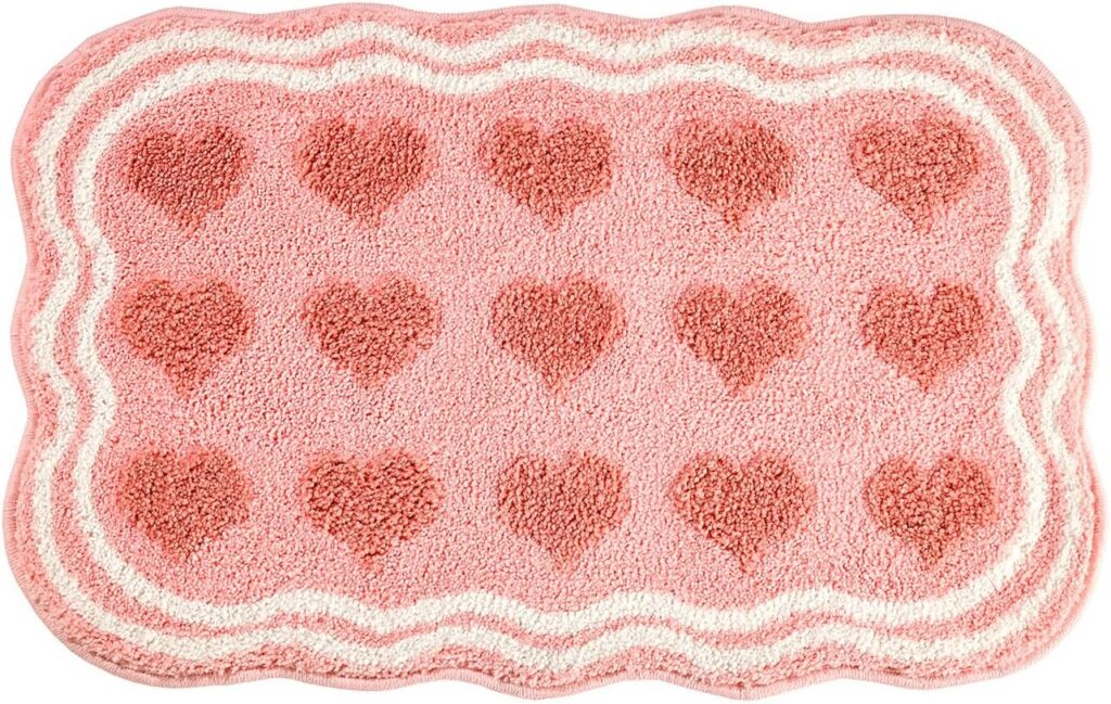Pink heart-pattern tufted bathroom rug with non-slip backing and plush absorbent microfiber surface for bathrooms, bedrooms, and entryways