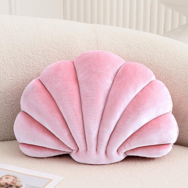 Pink velvet seashell-shaped throw pillow with soft plush filling for sofas, beds, nursery decor, and coastal-inspired spaces