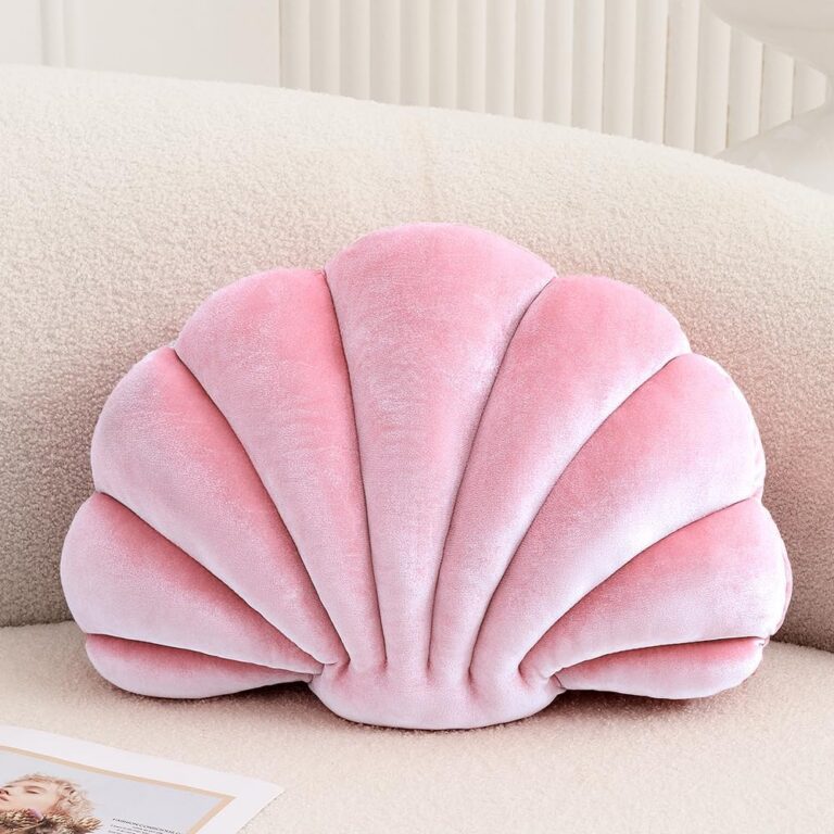 Pink velvet seashell-shaped throw pillow with soft plush filling for sofas, beds, nursery decor, and coastal-inspired spaces