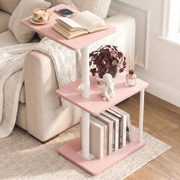 Pink adjustable C-shaped side table with a 360-degree swivel tabletop and three-tier storage shelves for use beside sofas, recliners, or beds in small living spaces.