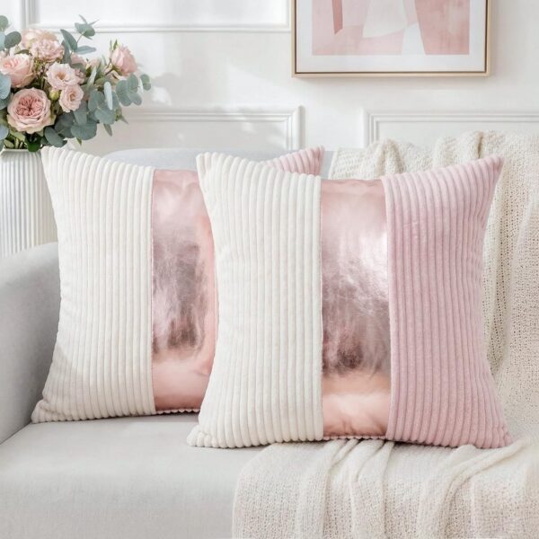 Set of two pink and cream striped corduroy throw pillow covers with gold faux leather patchwork, reversible decorative cushion covers for couches, sofas, and living rooms.
