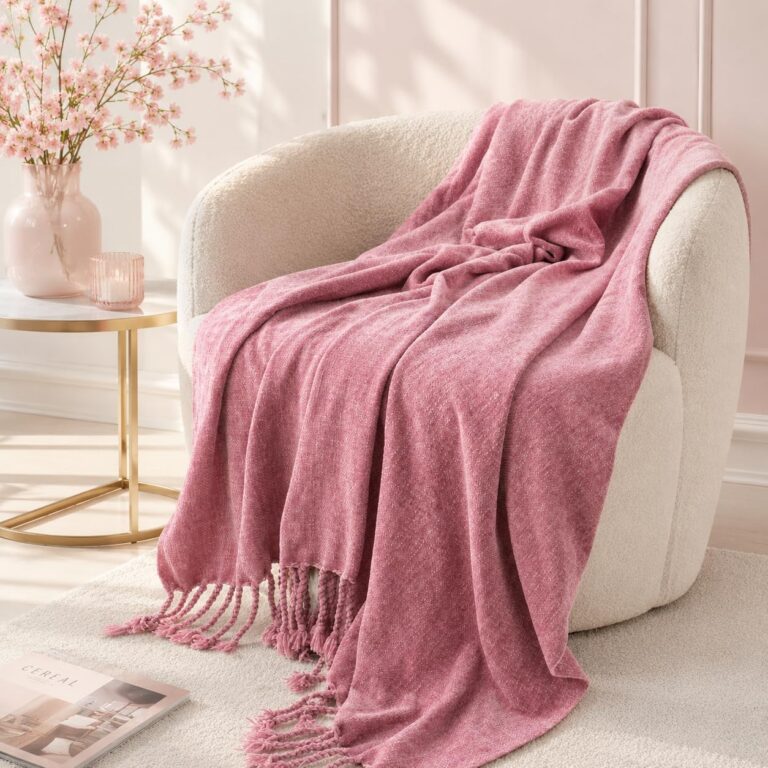 Blush pink chenille knit throw blanket with textured weave and handmade fringe tassels, lightweight decorative blanket for sofas, beds, chairs, and cozy home décor.
