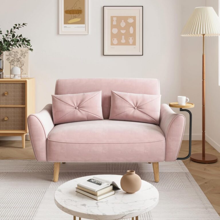 Brelice pink velvet loveseat sofa with a convertible wooden armrest tray, curved ergonomic armrests, thick foam cushions, and two matching throw pillows, designed for apartments, bedrooms, home offices, and small living spaces.