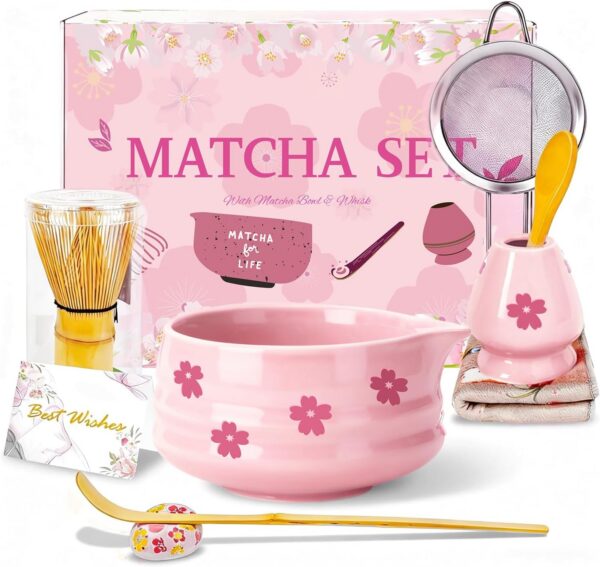 Pink Sakura ceramic matcha bowl set with bamboo whisk, whisk holder, scoop, sifter, tea cloth, and traditional matcha accessories for preparing ceremonial green tea.