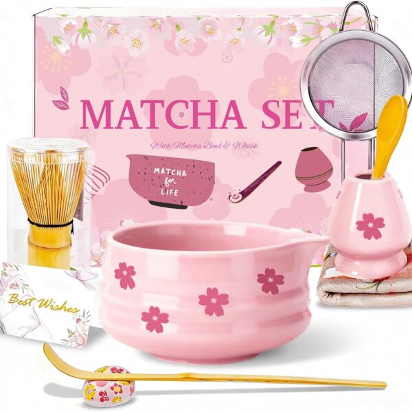 Pink Sakura ceramic matcha bowl set with bamboo whisk, whisk holder, scoop, sifter, tea cloth, and traditional matcha accessories for preparing ceremonial green tea.