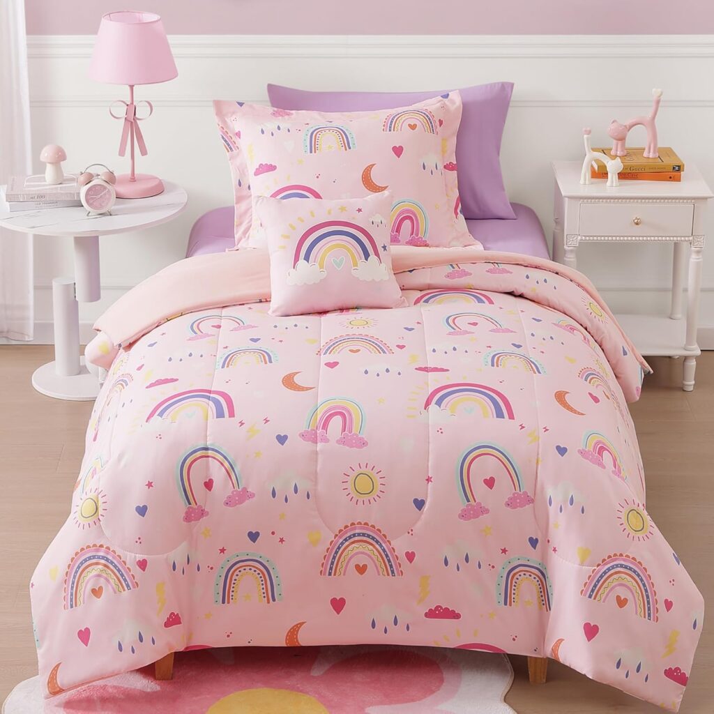 Glow-in-the-dark twin comforter set featuring a pink rainbow design with a matching pillow sham and decorative accent pillow, made from soft microfiber for comfortable all-season kids' bedding.
