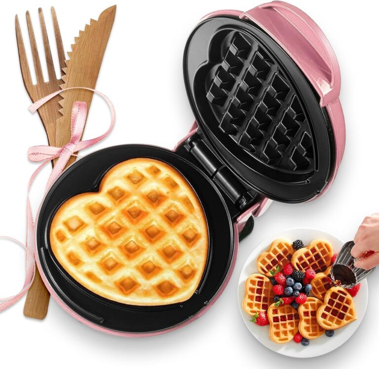 Compact pink mini heart-shaped waffle maker with 4-inch nonstick cooking plates for waffles, paninis, hash browns, and other quick breakfast recipes.