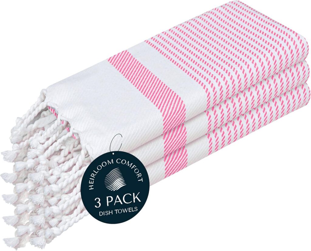 Set of three HEIRLOOM COMFORT rose pink Turkish kitchen towels made from 100% cotton with decorative tassels, featuring quick-drying, highly absorbent fabric for drying dishes, cleaning countertops, baking, and everyday kitchen use.