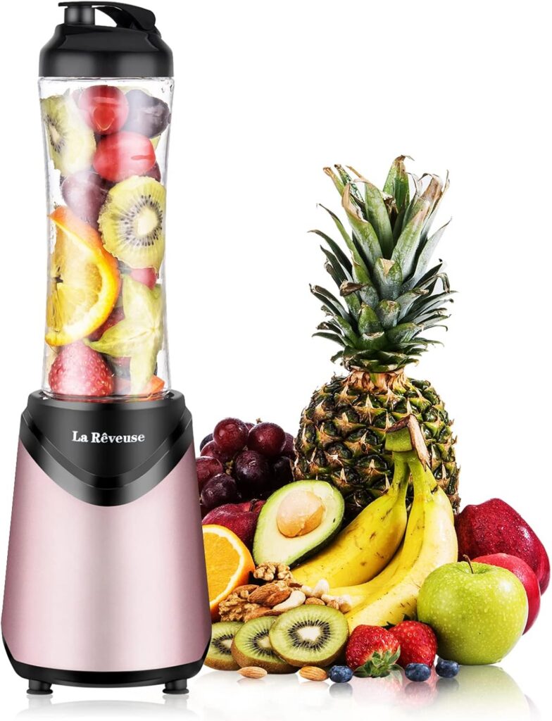 Pink La Reveuse personal smoothie blender with a 300-watt motor, 18-ounce BPA-free travel bottle, stainless steel blades, and sip-and-seal lid for smoothies, protein shakes, and fresh drinks.