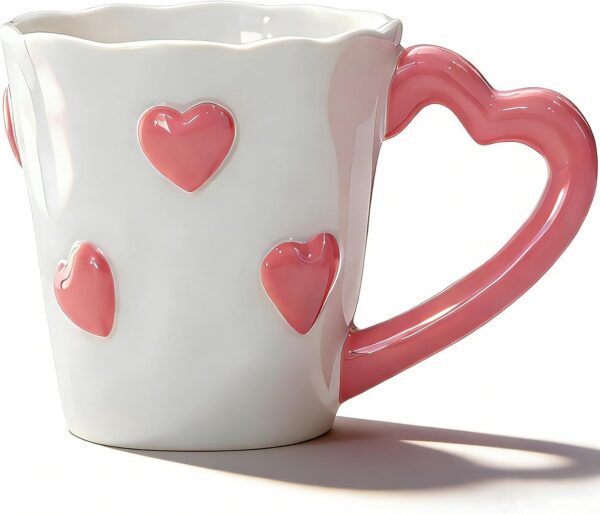 Oxmidud pink 8.5-ounce ceramic coffee mug featuring embossed 3D hearts, a heart-shaped handle, and a glossy finish for coffee, tea, lattes, cappuccinos, and hot chocolate.