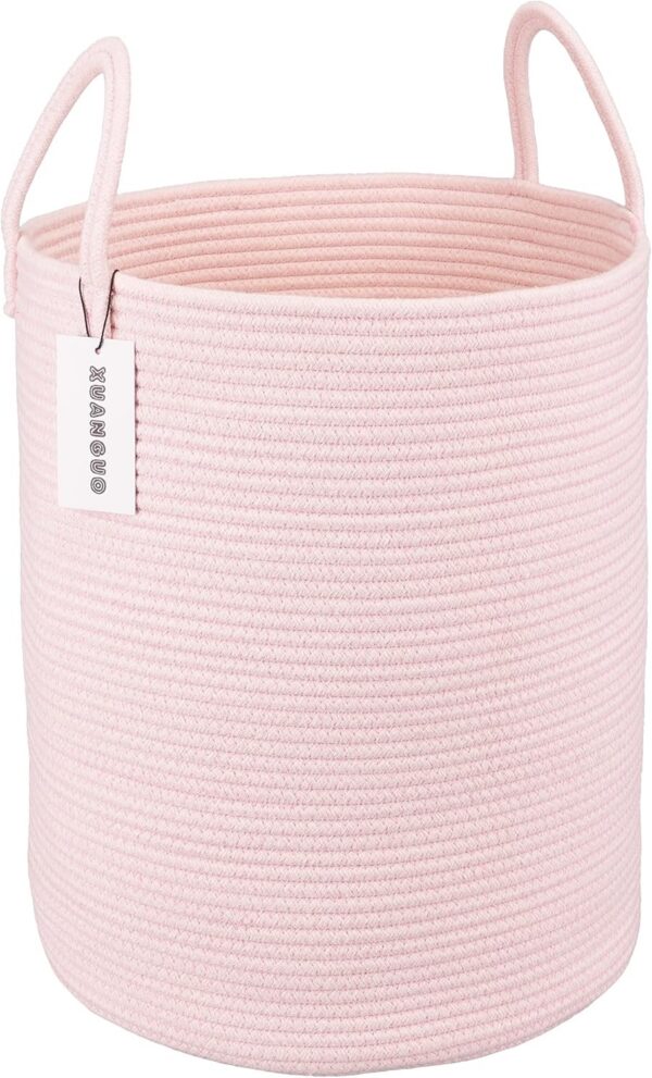 Large light pink woven cotton rope laundry basket with reinforced handles, round 58-liter storage hamper for laundry, blankets, toys, towels, and nursery organization.