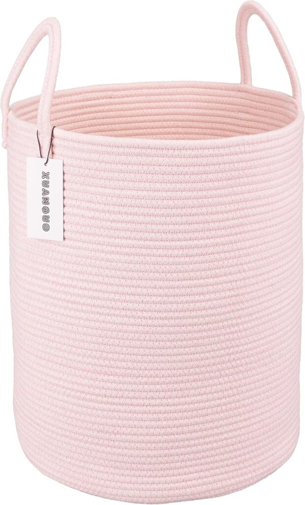 Large light pink woven cotton rope laundry basket with reinforced handles, round 58-liter storage hamper for laundry, blankets, toys, towels, and nursery organization.