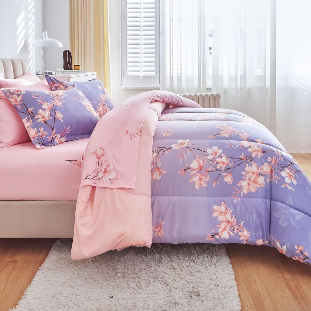 Pink and light purple queen comforter set featuring a botanical blossom branch print with coordinating sheets, pillow shams, and pillowcases in a soft microfiber 7-piece bed in a bag set for all-season comfort.
