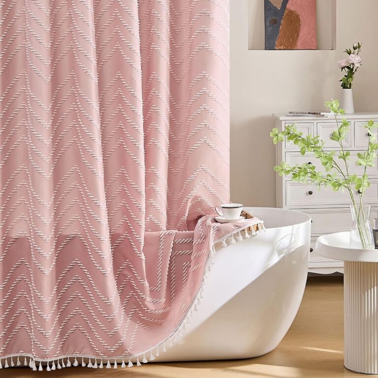 Pink boho fabric shower curtain with tufted chevron texture, decorative tassels, waterproof woven polyester fabric, and 72 x 72-inch design for farmhouse-inspired bathroom décor.