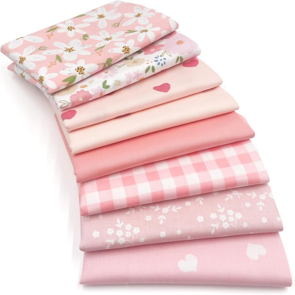 Eight-piece Sweet Pink fat quarter fabric bundle made from 100% cotton with coordinating floral, heart, stripe, and pink patterned 20 x 20 inch pre-cut squares for quilting, patchwork, sewing, and craft projects.