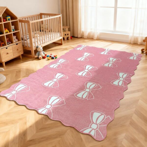 Pink 4x6 area rug with a decorative bow design, scalloped edges, soft faux cashmere surface, machine-washable construction, and non-slip TPE rubber backing for bedrooms, nurseries, dorm rooms, and living spaces.