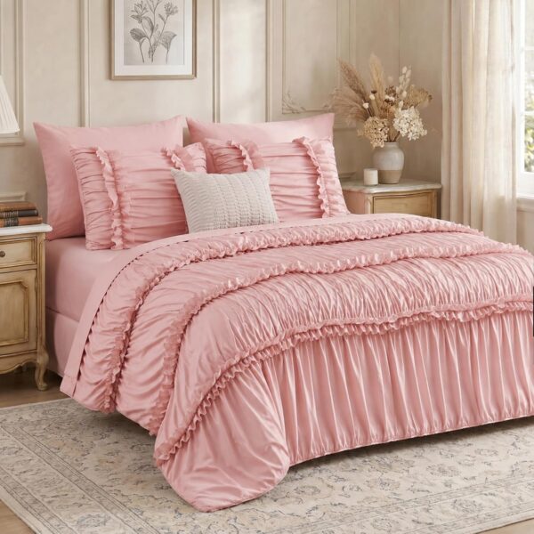 Lipa pink queen comforter set featuring ruched fabric, layered ruffle trim, and bow details, with matching sheets, pillow shams, and pillowcases.